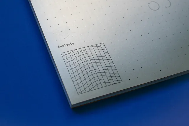 Analysis grid notebook flat lay, photographic, minimal, dark