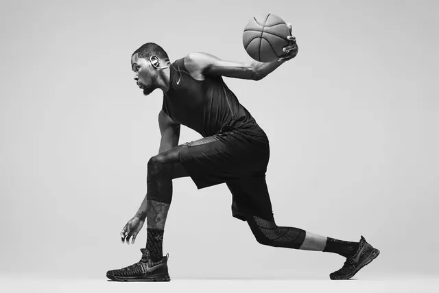 Basketball player mid-action black and white portrait, photographic, monochrome, dark