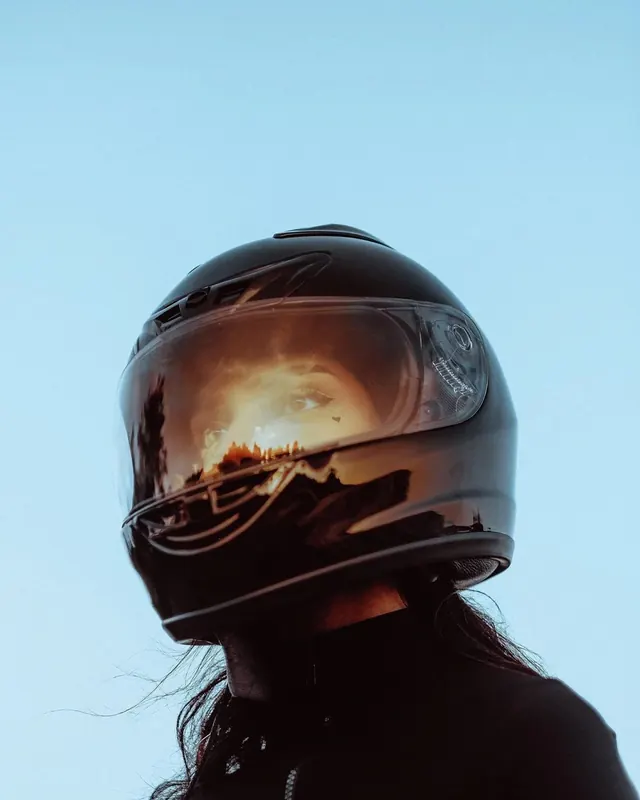 Motorcycle helmet sunset reflection portrait, photographic, editorial, light