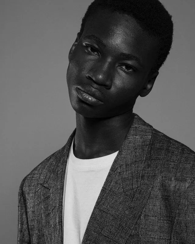 Monochrome male portrait headshot, minimal, photographic, dark