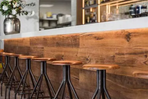 Wooden Bar Counter with Metal Stools, photographic, industrial, warm