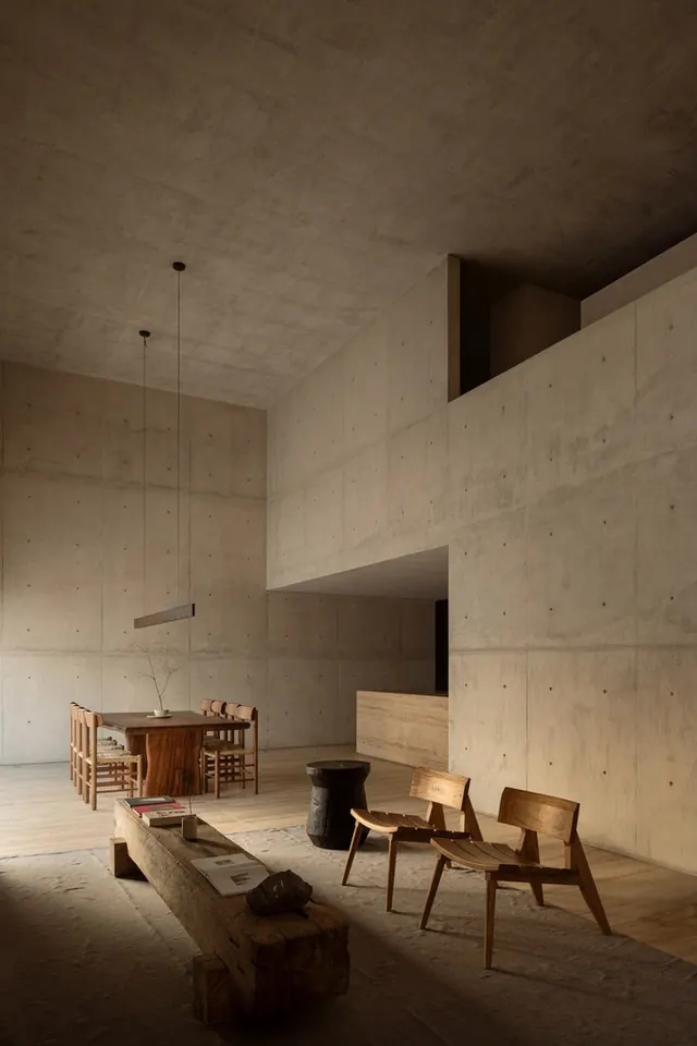 Brutalist concrete interior with minimal furnishing, brutalist, minimal, muted
