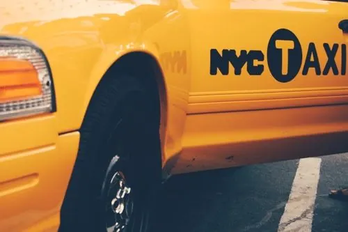 NYC yellow taxi detail with medallion logo, photographic, vibrant