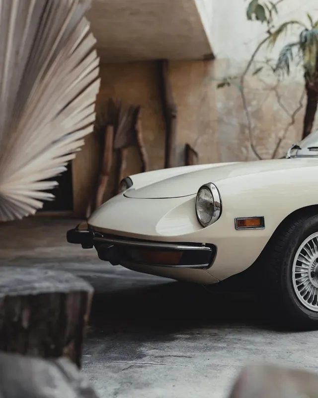 Vintage car profile in minimalist interior, photographic, minimal, warm