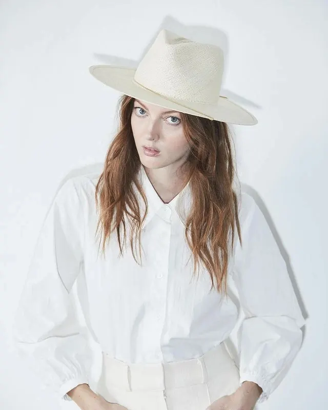 Portrait with cream cowboy hat and structured clothing, photographic, minimal, light
