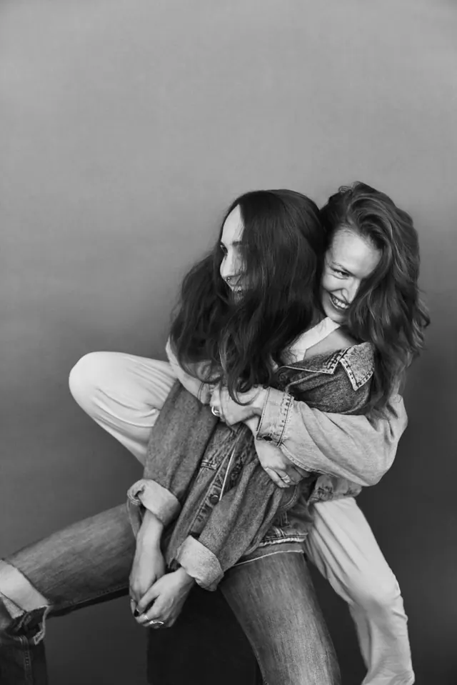 Black-and-white portrait of two people in casual pose, photographic, minimalist, monochrome