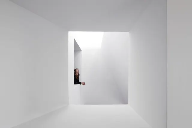 Figure in white space architectural composition, photographic, minimalist, light