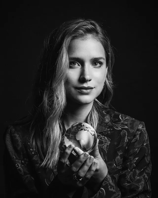 Studio portrait with glass globe, monochrome, photographic, monochrome