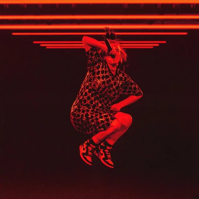 Red-lit concert performance jump shot, photographic, dramatic, dark