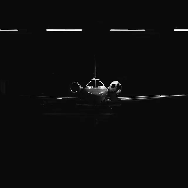 Silhouetted aircraft front-on minimalist, photographic, minimalist, dark