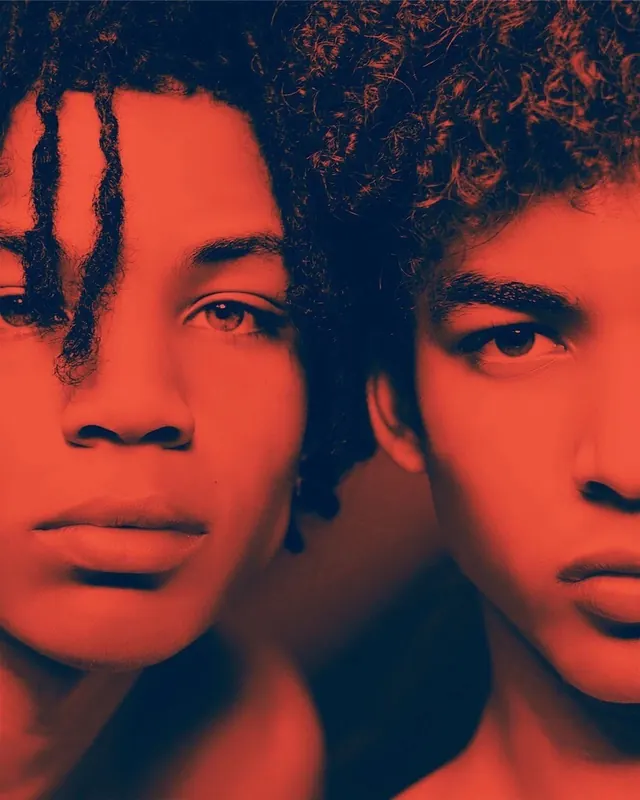 Dual-tone portrait with red and blue lighting, photographic, dark-mode, duotone