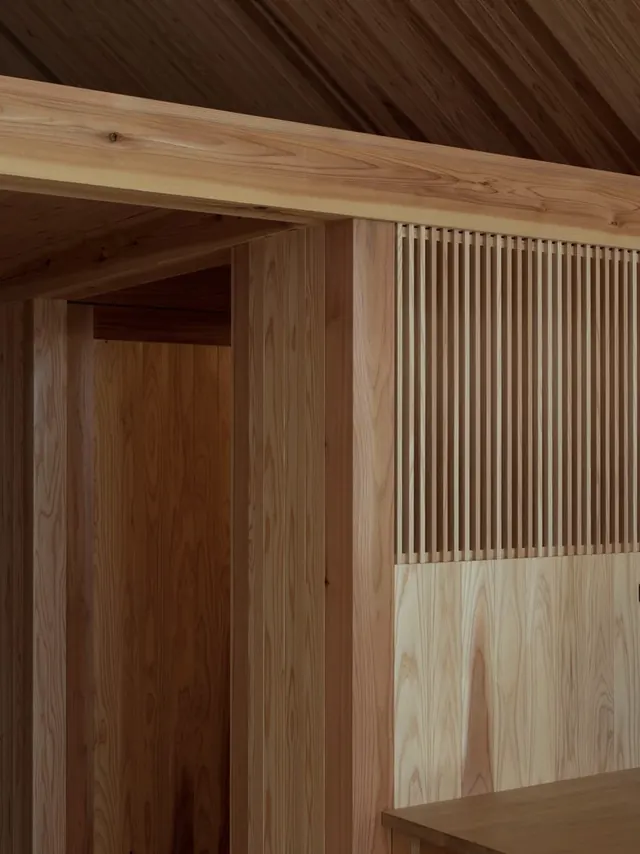 Interior architectural detail with vertical wood slat wall treatment, photographic, minimal, warm