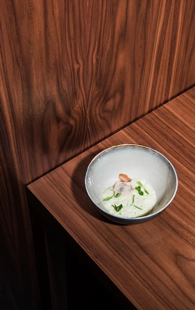Murri Restaurant dish on wood, minimal, photographic, warm