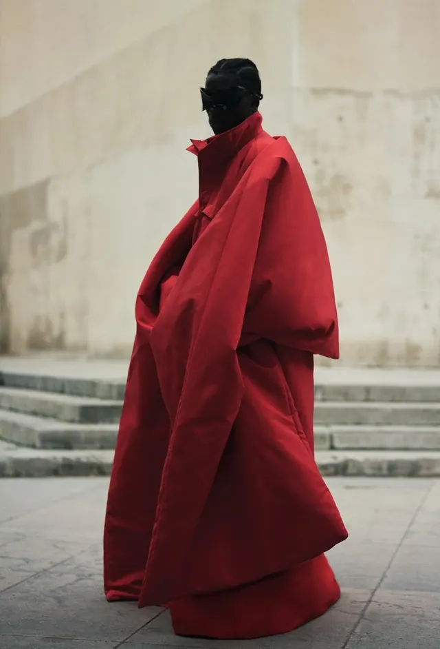 Fashion editorial with oversized red coat, photographic, editorial, dark