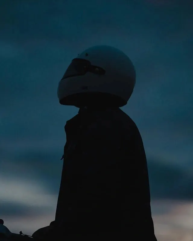 Silhouetted figure against teal sky, photographic, dark-mode, dark
