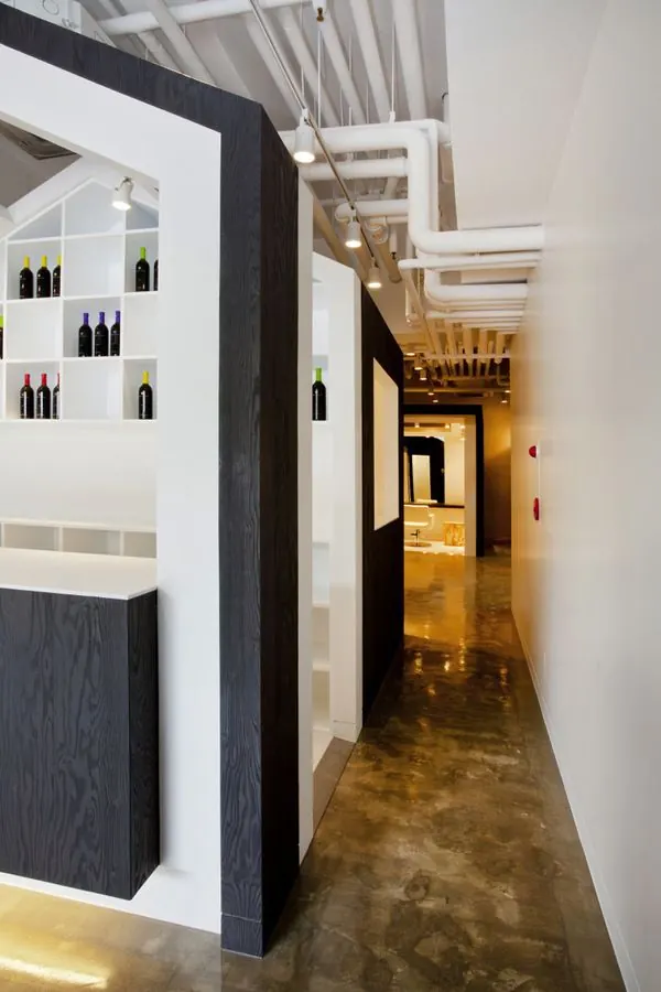 Wine bottle retail display with dark wood accent, minimal, corporate-clean, light