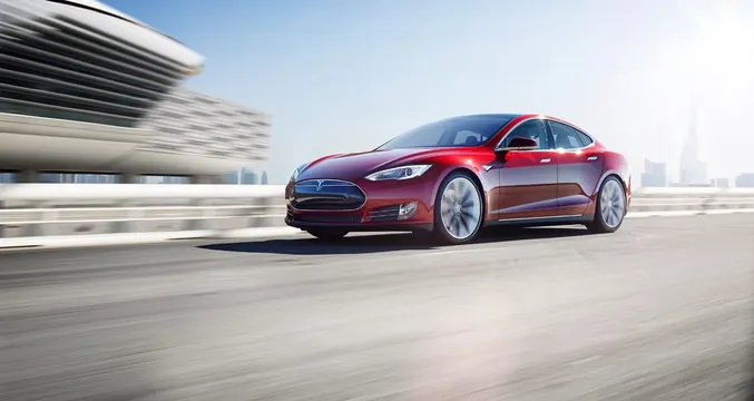 Red Tesla sedan in motion against modern architecture, photographic, technical, cool