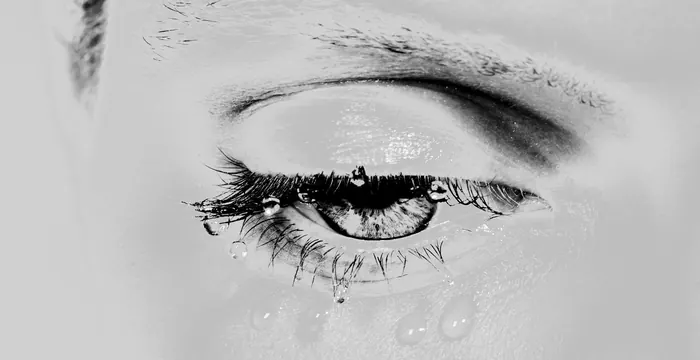 Close-up eye photograph with droplets, photographic, editorial, monochrome