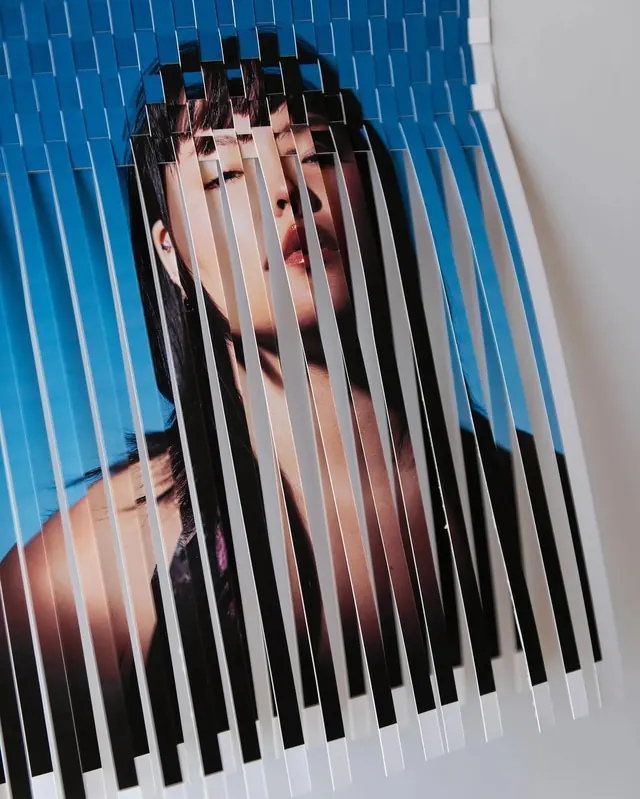 Portrait through slatted blue and black overlay, photographic, editorial, cool