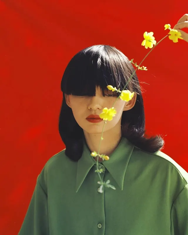 Portrait with floral arrangement, photographic, playful, vibrant