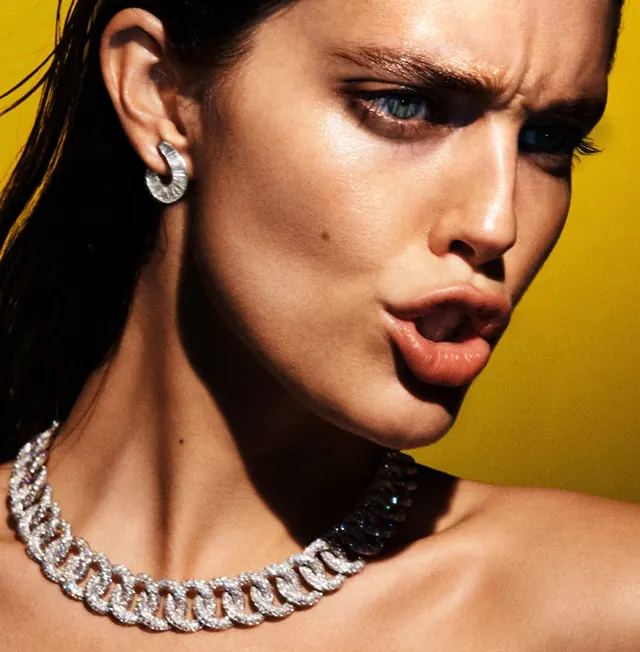 Portrait with jewelry and yellow background, photographic, minimal, warm