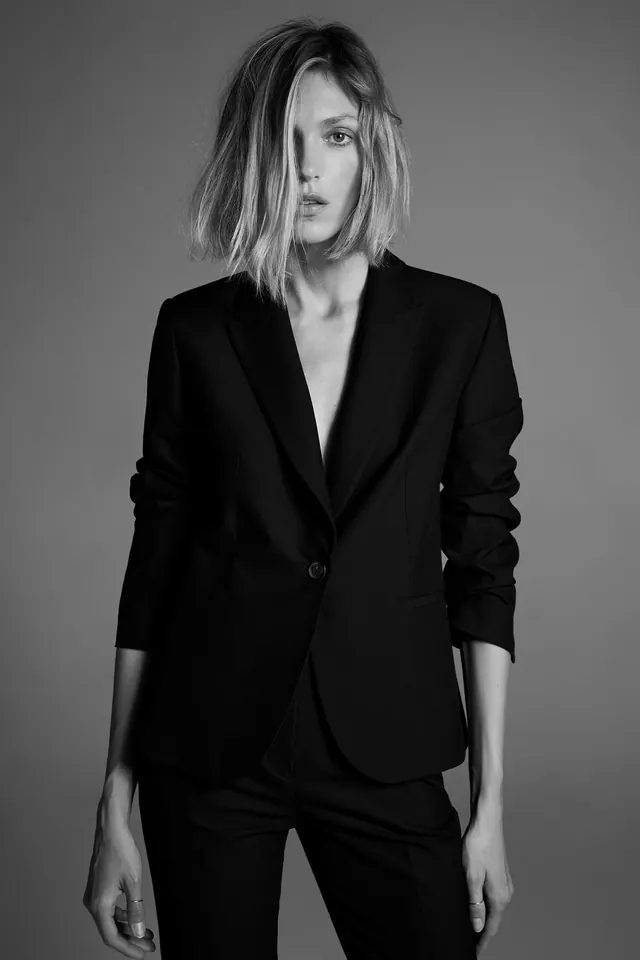 Basic black blazer on model, photographic, minimal, dark