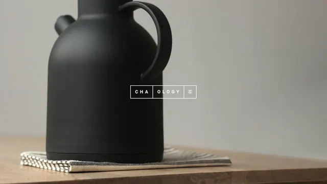 Black ceramic pitcher with branding overlay, minimal, corporate-clean, dark