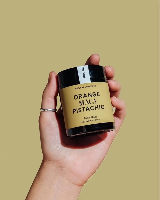 Natural food product packaging with hand holding, photographic, minimal, warm
