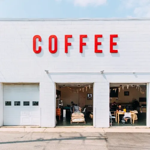 Bold red COFFEE storefront signage, minimal, corporate-clean, light