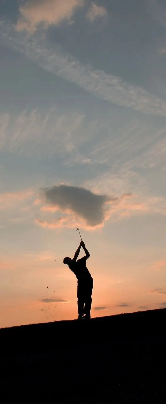 Golfer silhouette at sunset, photographic, organic, warm