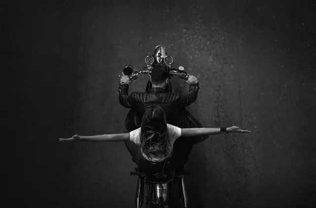 Overhead motorcycle portrait in black and white, photographic, dark-mode, monochrome