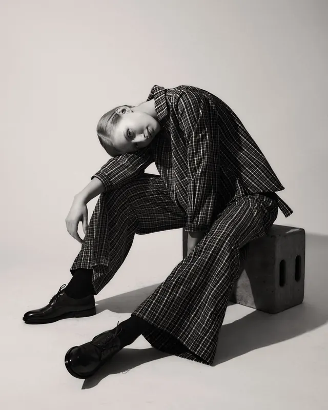 Fashion portrait in oversized plaid suit, photographic, minimal, monochrome