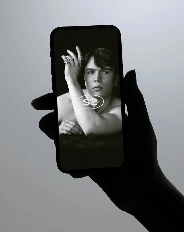 Portrait through smartphone screen, editorial, monochrome, dark