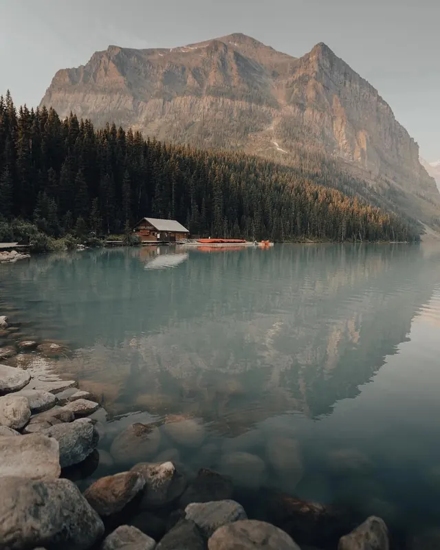 Alpine lake with boathouse and mountain, photographic, light-mode, cool