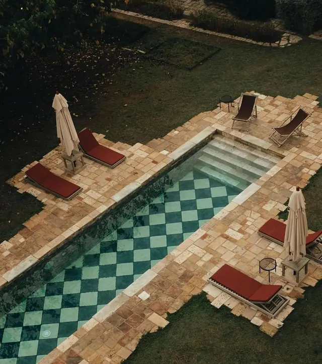 Luxury poolside lounge with geometric tile pattern, luxury, minimalist, warm