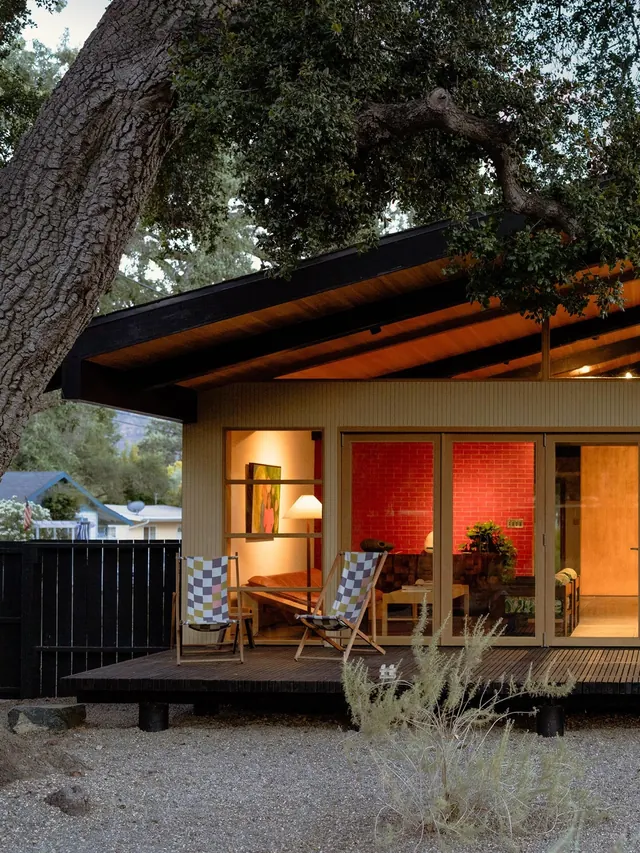 Mid-century modern cabin with warm accent lighting, photographic, architectural, warm