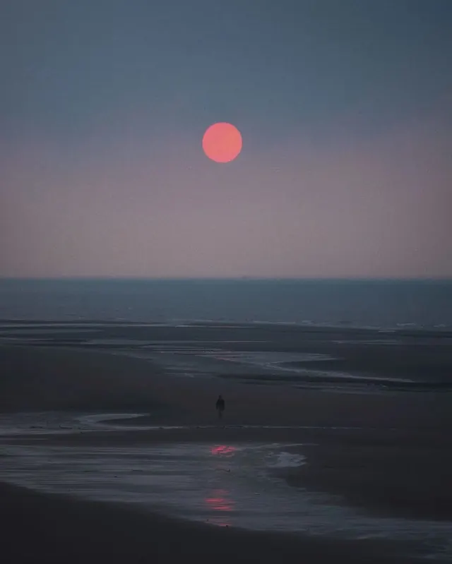 Sunset over calm water, photographic, dark-mode, dark