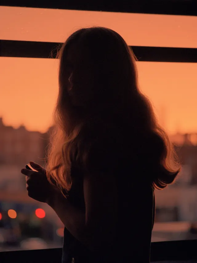 Silhouette against sunset and horizontal stripes, photographic, editorial, warm