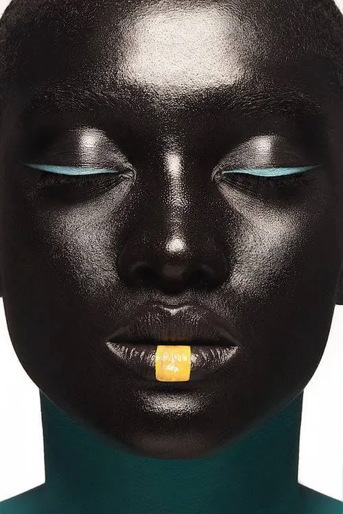 Dark face with teal and yellow accents, editorial, bold, dark