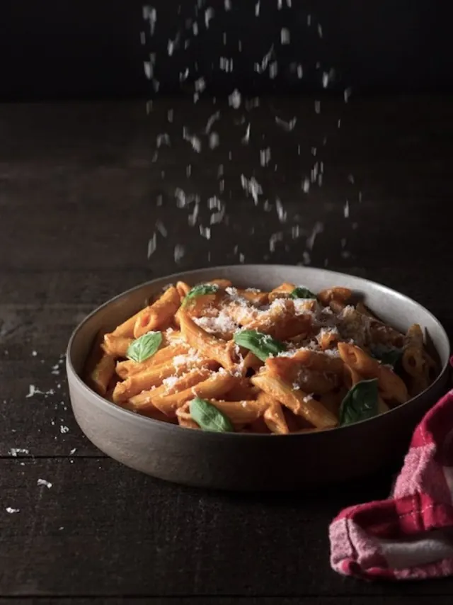 Penne pasta in creamy sauce food photography, photographic, minimal, dark