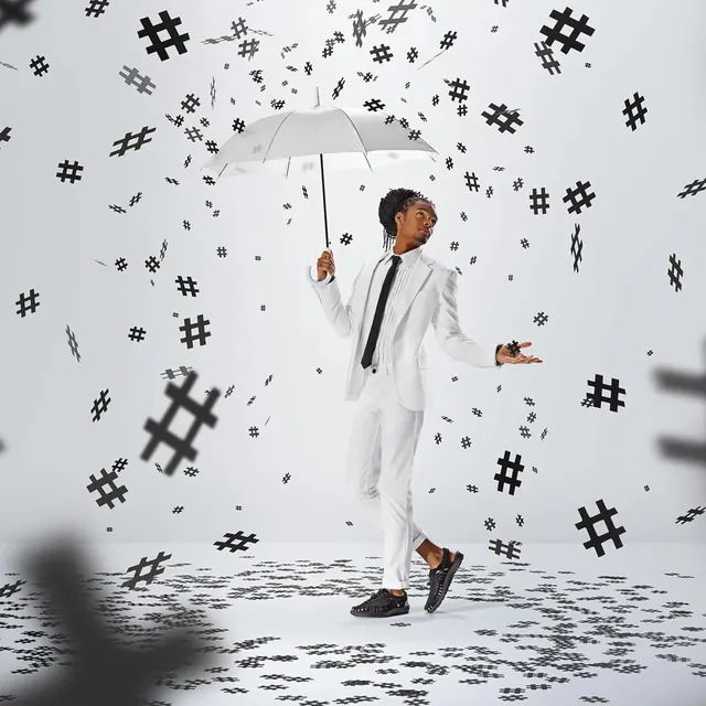 Man with umbrella and hashtags, playful, photographic, light