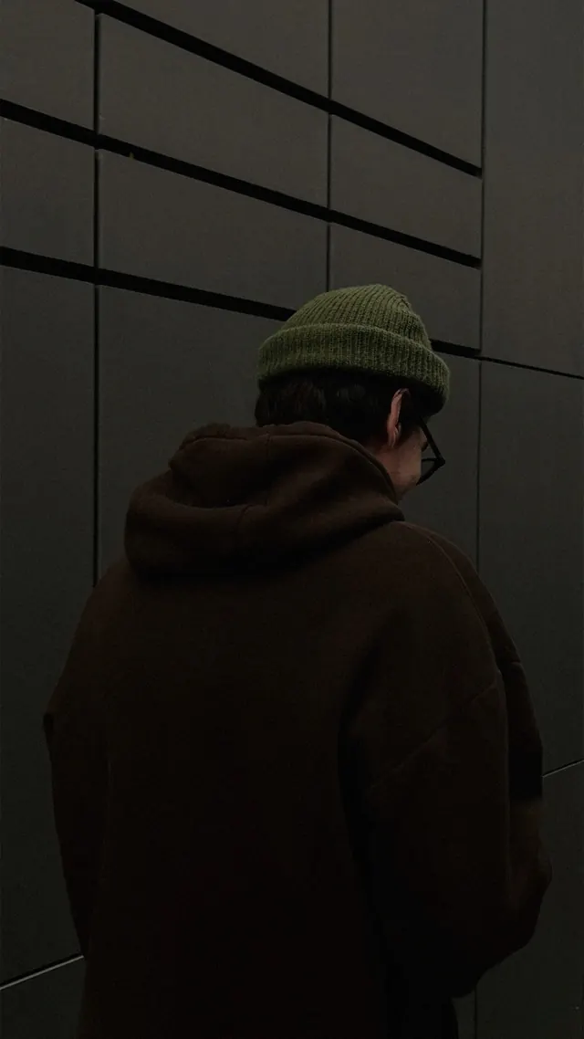 Portrait against geometric paneled wall, photographic, geometric, dark