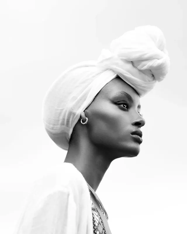 Black and white portrait with white turban headwrap, photographic, minimal, light