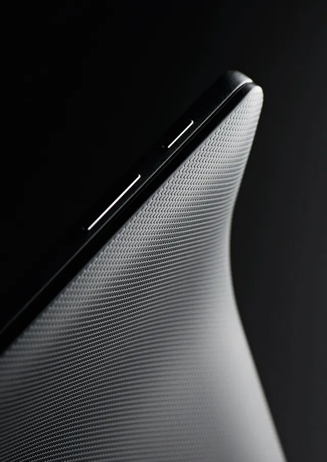 Curved architecture detail with textured surface, photographic, minimal, monochrome