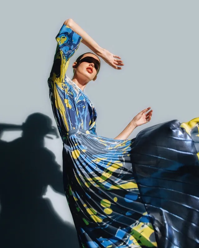 Portrait with geometric printed fabric flowing, photographic, illustrated, vibrant