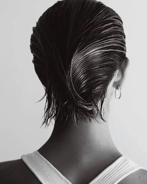 Black and white portrait photography, back view with flowing hair, monochrome, photographic, dark