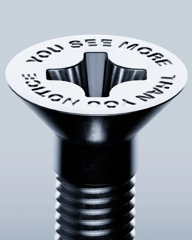 Embossed lightbulb typographic product, photographic, dark