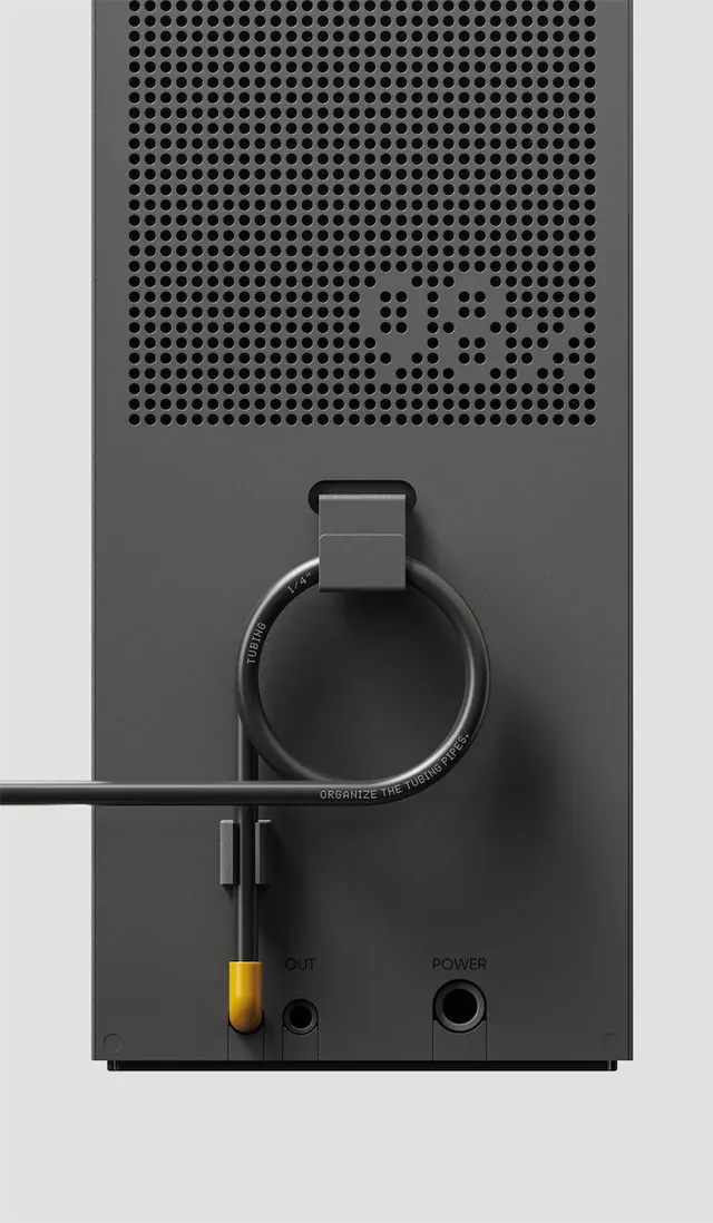 Audio speaker with perforated grille and controls, photographic, technical, dark