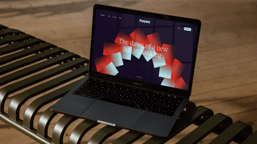 Tuum homepage on a laptop, animated hero in situ, photographic, dark-mode, dark